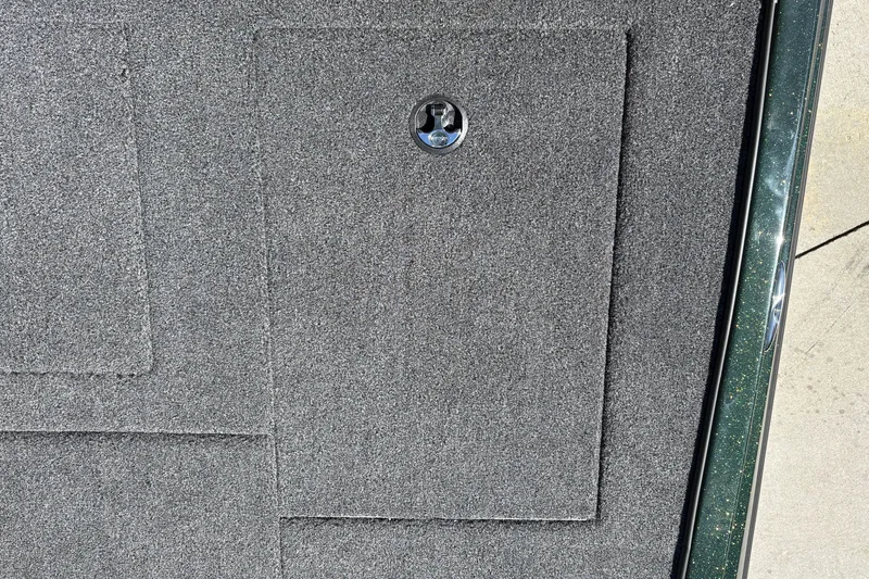 Slide: The Image of Gray carpeted deck of 2027 Nitro Z18 XL boat with a metal latch. - 47