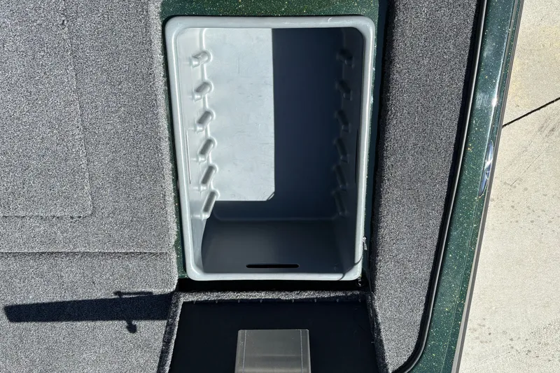 Slide: The Image of Open storage compartment in 2027 Nitro Z18 XL boat, featuring carpeted interior. - 36