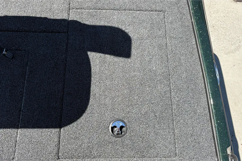 Slide: The Image of Carpeted deck of 2027 Nitro Z18 XL boat with latch and shadow. - 42