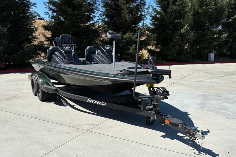 Slide: The Image of 2027 Nitro Z18 XL boat on trailer, parked outdoors with trees in background. - 3