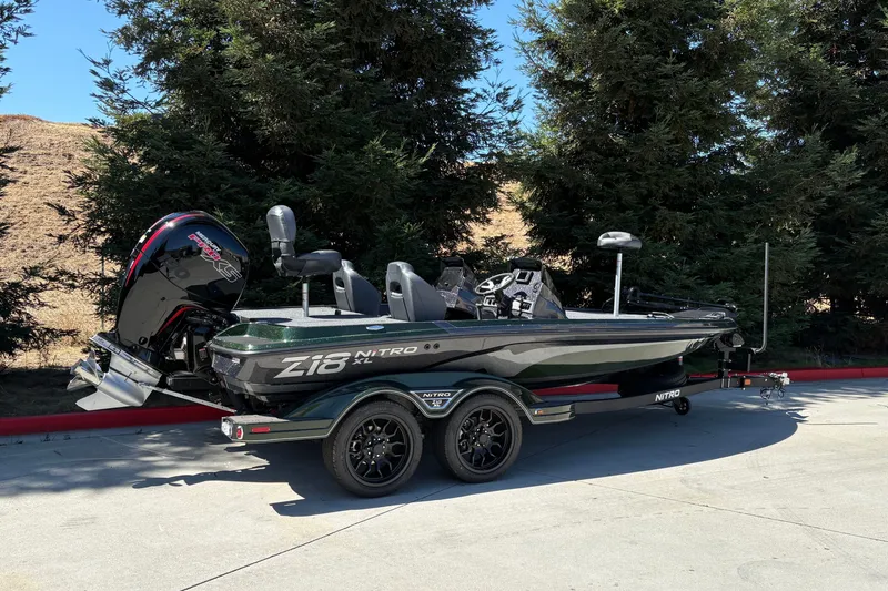 Slide: The Image of 2027 Nitro Z18 XL boat on trailer, parked outdoors near trees. - 4