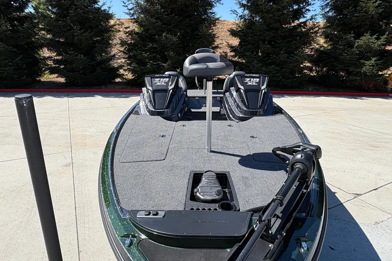 Slide: The Image of 2027 Nitro Z18 XL boat with dual seats and trolling motor, parked outdoors. - 17