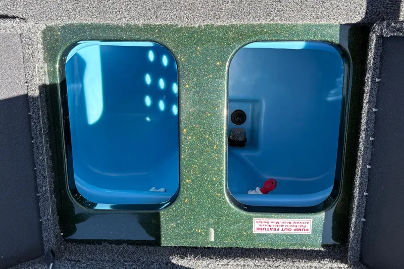 Slide: The Image of Livewell compartments in a 2027 Nitro Z18 XL boat, featuring blue interiors and pump-out feature. - 34