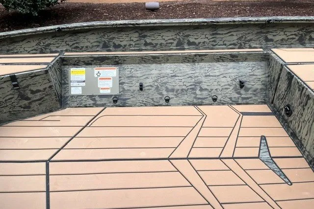 Slide: The Image of 2027 Tracker Grizzly 1553 Timber boat interior with camouflage design and tan flooring. - 13