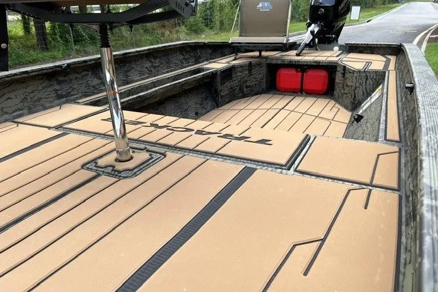 Slide: The Image of 2027 Tracker Grizzly 1553 Timber boat interior with tan decking and storage compartments. - 16