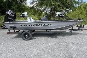 The Image of 2027 Tracker Pro Team 175 boat on trailer, parked outdoors. - 0