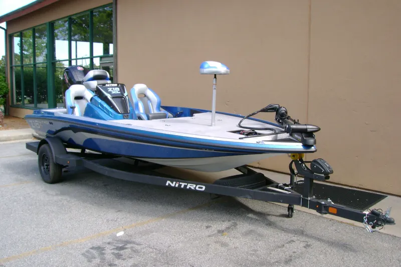 Slide: The Image of 2027 Nitro Z18 XL boat on trailer, parked outdoors, showcasing sleek design and modern features. - 4