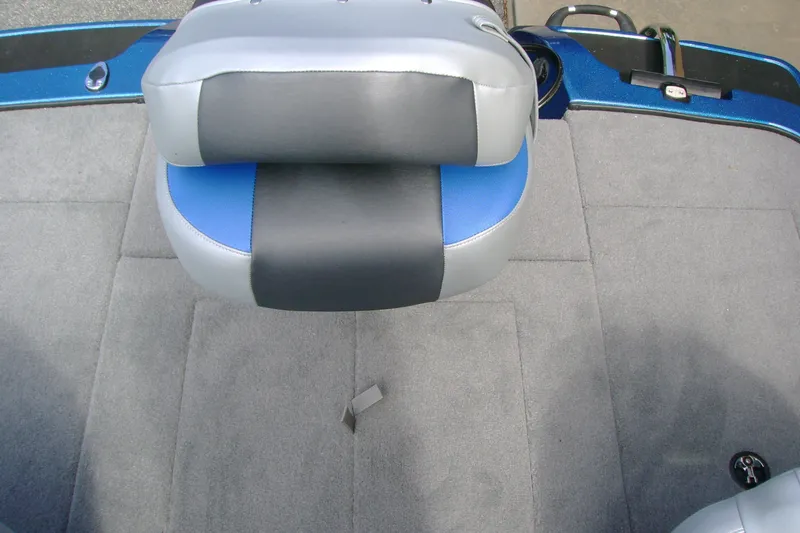 Slide: The Image of 2027 Nitro Z18 XL boat seat with gray and blue upholstery on a carpeted deck. - 12