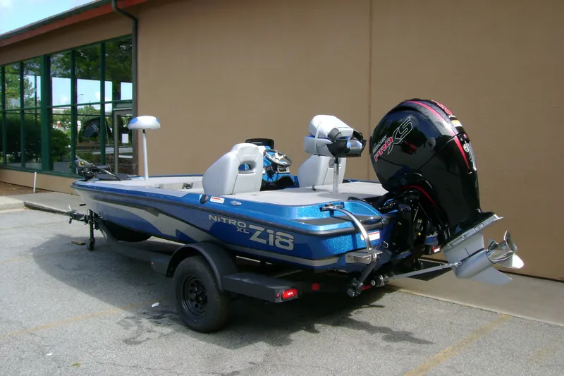 Slide: The Image of 2027 Nitro Z18 XL boat with powerful outboard motor, parked outdoors. - 6