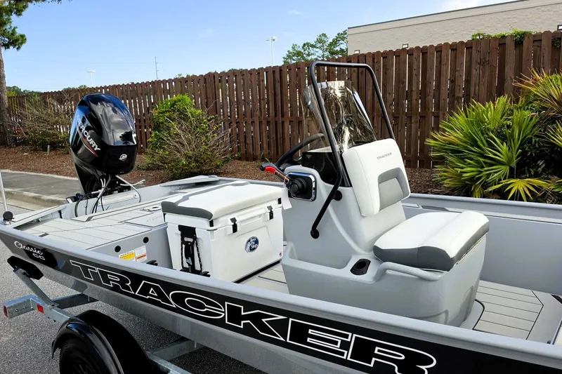 Slide: The Image of 2027 Tracker Bass Tracker Classic CC boat with Mercury engine, parked outdoors. - 13