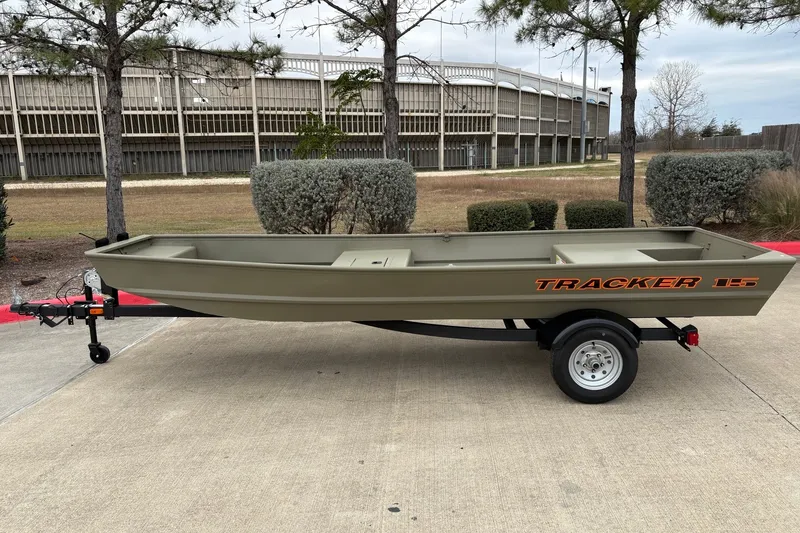 The Image of A 2027 Tracker Grizzly 15 Jon boat on a trailer, parked on a concrete lot. - 0