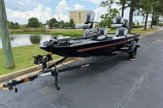 The Image of 2027 Tracker Bass Tracker Classic XL boat on trailer, parked near a pond. - 0