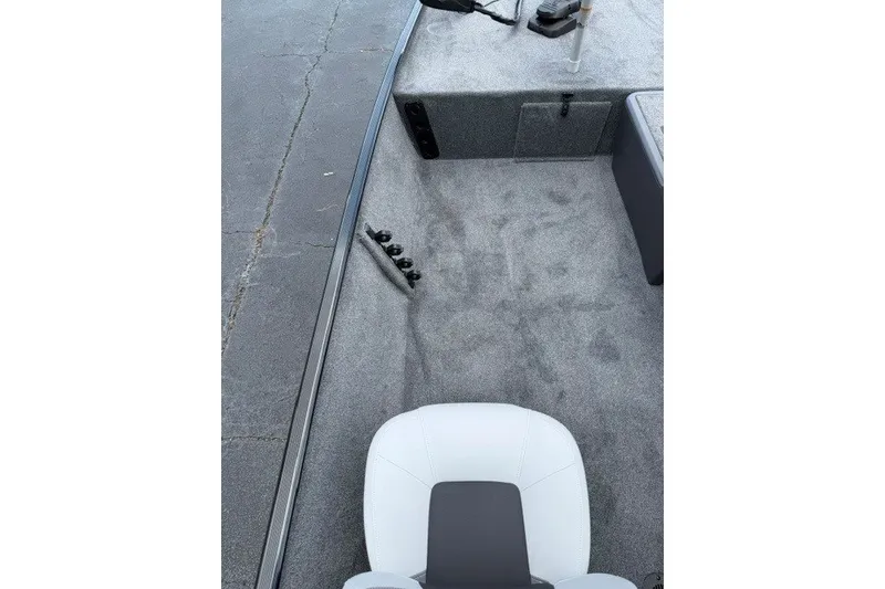 Slide: The Image of 2027 Tracker Bass Tracker Classic XL boat interior with gray carpet and white seat. - 13
