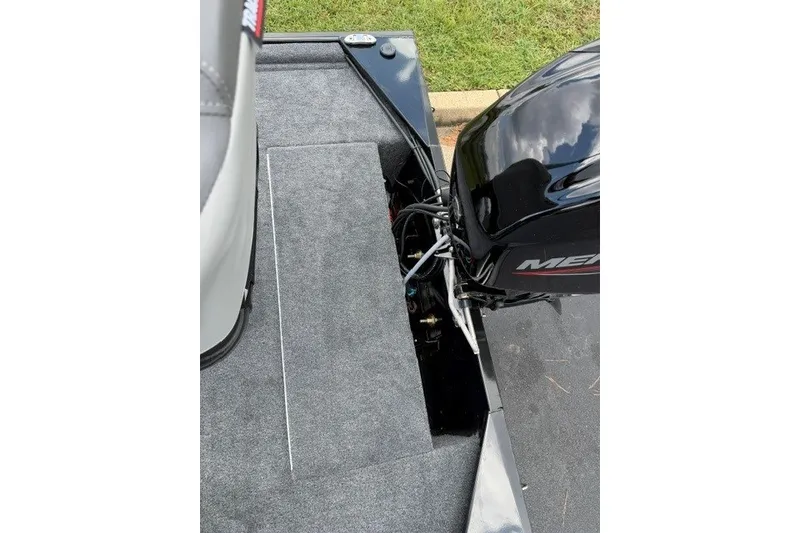 Slide: The Image of 2027 Tracker Bass Tracker Classic XL boat with Mercury outboard motor, featuring carpeted deck. - 16