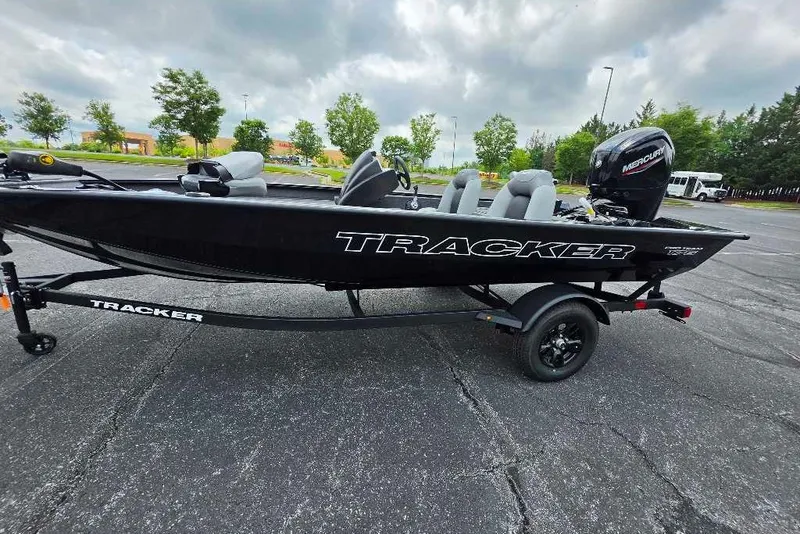 The Image of 2027 Tracker Pro Team 175 boat on trailer in parking lot. - 0