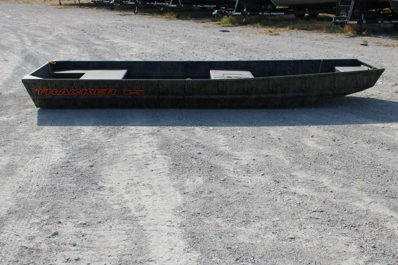 The Image of 2027 Tracker Grizzly 15 Jon boat on gravel surface, side view. - 0