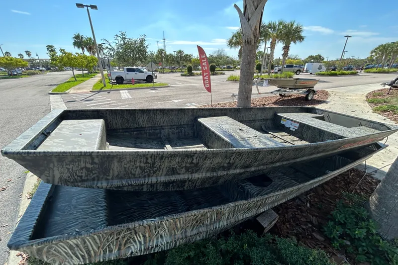 The Image of 2027 Tracker Grizzly 15 Jon boat displayed outdoors, camo design, for sale. - 0