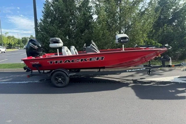 The Image of Red 2027 Tracker Pro Team 175 boat on trailer, parked outdoors. - 0