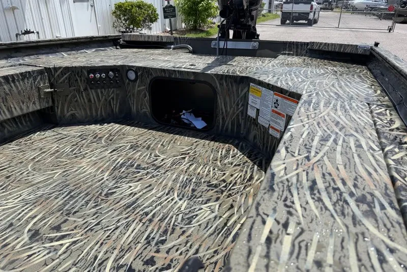 Slide: The Image of 2027 Tracker Grizzly 1654 T Sportsman boat interior with camouflage design and control panel. - 14