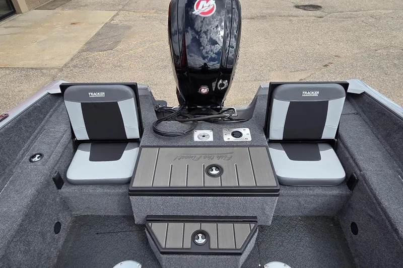 Slide: The Image of 2027 Tracker Pro Guide V-175 Combo boat interior with seating and motor. - 13