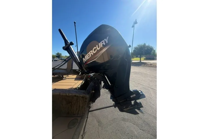 Slide: The Image of 2027 Tracker Grizzly 1553 Timber boat with Mercury outboard motor in sunlight. - 27