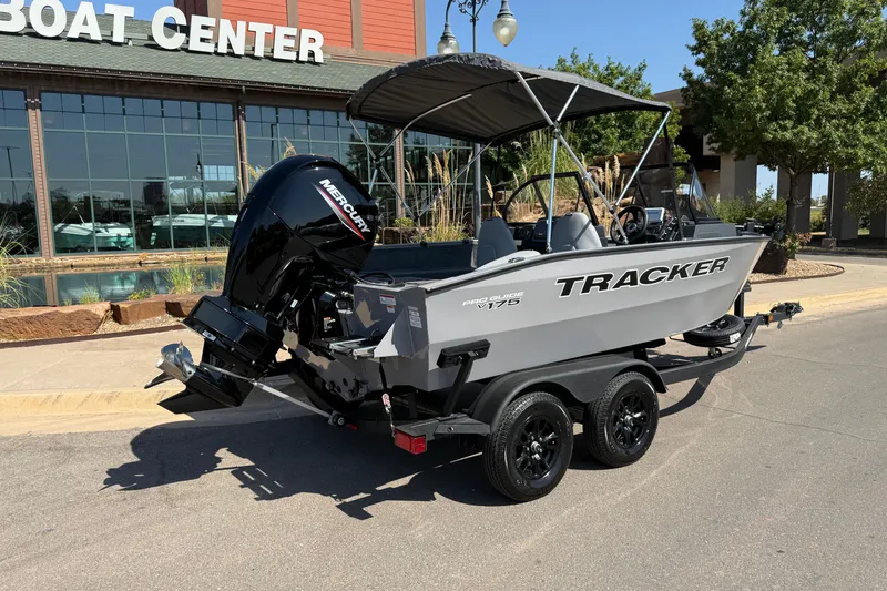 Slide: The Image of 2027 Tracker Pro Guide V-175 Combo boat on trailer outside a boat center. - 15