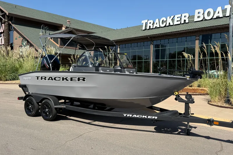 Slide: The Image of 2027 Tracker Pro Guide V-175 Combo boat on trailer outside Tracker Boats store. - 14