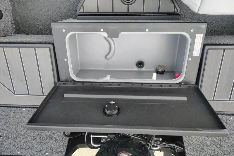Slide: The Image of 2027 Tracker Pro Guide V-175 Combo boat storage compartment with open lid. - 50