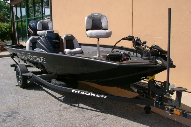 The Image of 2027 Tracker Pro Team 175 fishing boat on trailer, parked outdoors. - 0