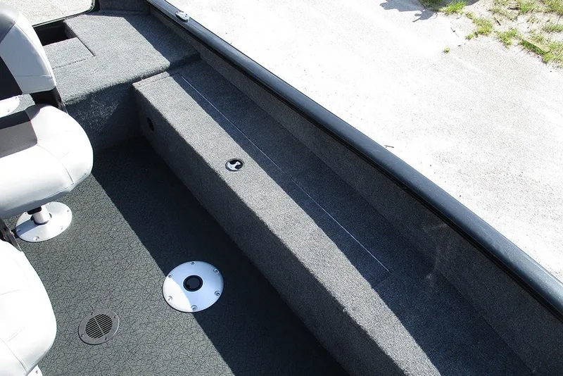 Slide: The Image of Interior of 2027 Tracker Super Guide V-16 SC boat, featuring seating and carpeted flooring. - 16