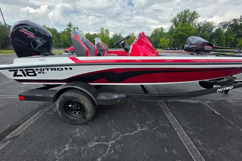 Slide: The Image of 2027 Nitro Z18 XL boat on trailer, red and white design, parked outdoors. - 7
