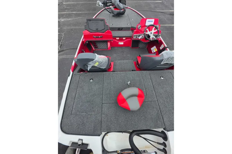 Slide: The Image of 2027 Nitro Z18 XL boat interior with red and gray seating, steering console, and carpeted deck. - 10