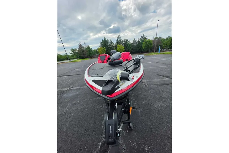 Slide: The Image of 2027 Nitro Z18 XL boat parked on asphalt under cloudy sky. - 1