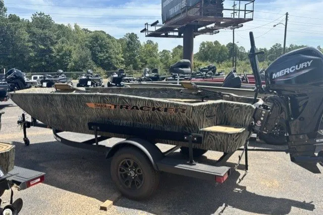 The Image of 2027 Tracker Grizzly 1553 Timber boat with Mercury engine on trailer in outdoor setting. - 0