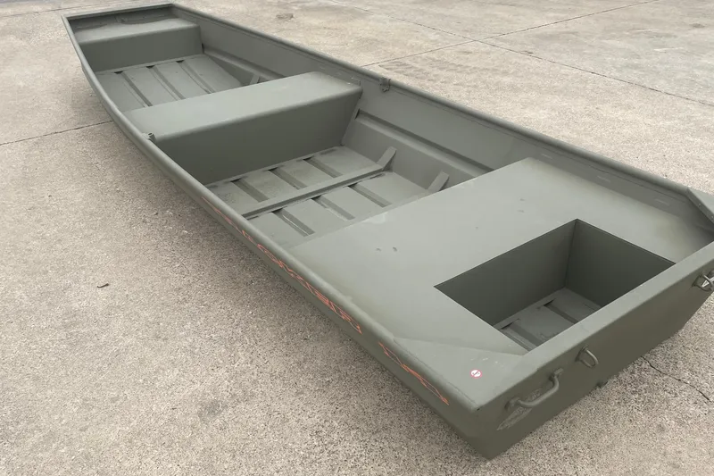 The Image of 2027 Tracker Grizzly 14 Jon boat on concrete surface, showcasing spacious interior design. - 0