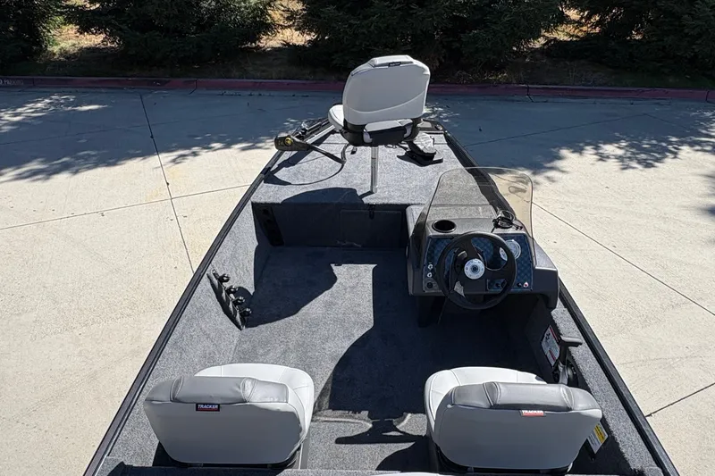 Slide: The Image of 2027 Tracker Bass Tracker Classic XL boat interior with seating and steering console. - 13
