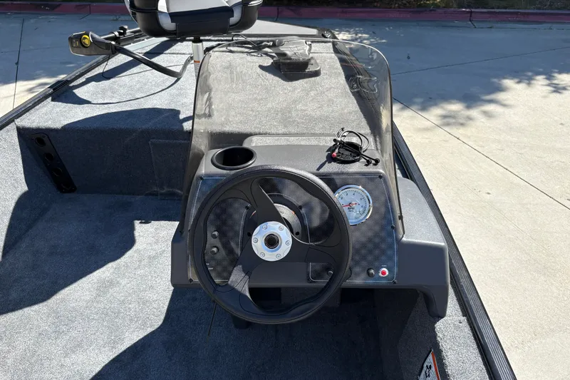 Slide: The Image of 2027 Tracker Bass Tracker Classic XL boat dashboard with steering wheel and gauges. - 21
