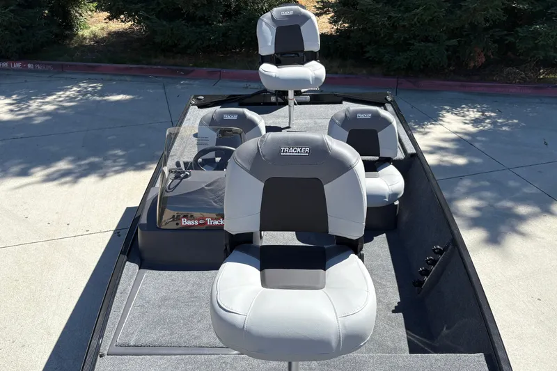 Slide: The Image of 2027 Tracker Bass Tracker Classic XL boat with gray seating, parked outdoors. - 20