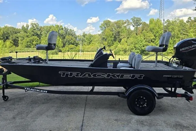 The Image of 2027 Tracker Pro 170 boat on trailer, parked outdoors with scenic background. - 0