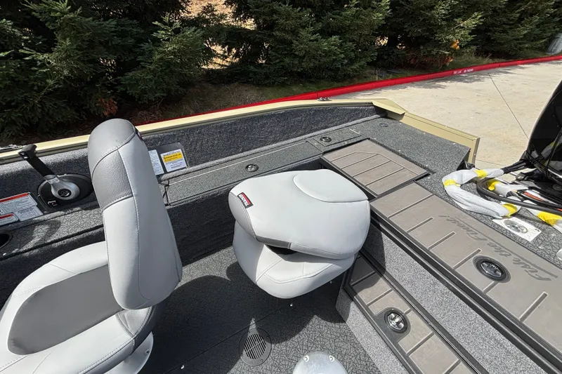 Slide: The Image of 2027 Tracker Pro Guide V-175 Combo boat interior with gray seating and storage compartments. - 27