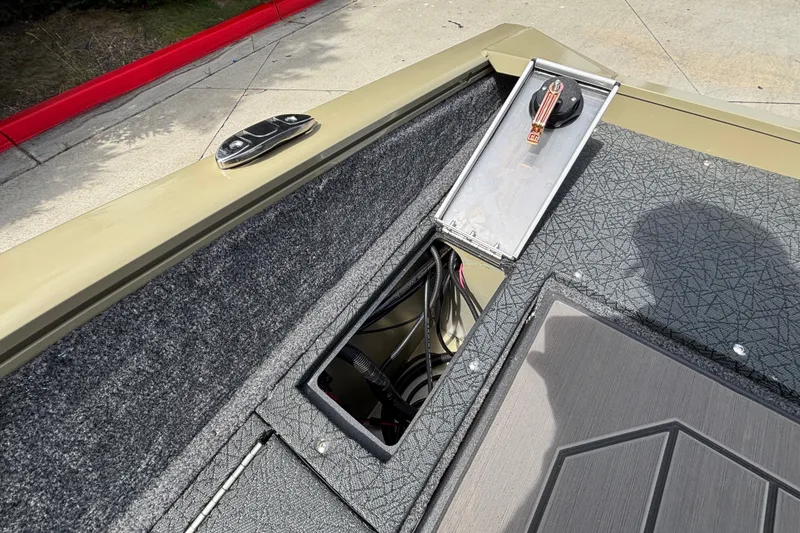 Slide: The Image of 2027 Tracker Pro Guide V-175 Combo boat interior with open storage compartment and wiring. - 44