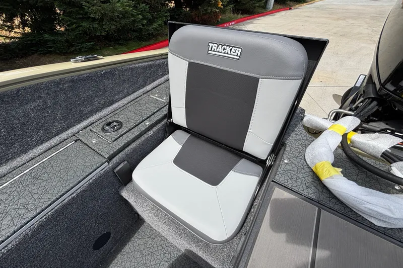 Slide: The Image of 2027 Tracker Pro Guide V-175 Combo boat seat, gray and black design, outdoor setting. - 30