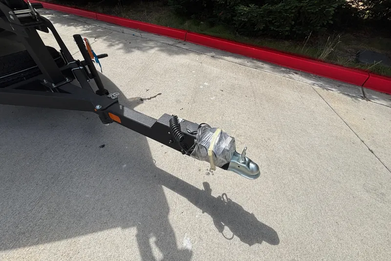 Slide: The Image of Trailer hitch of a 2027 Tracker Pro Guide V-175 Combo on concrete pavement. - 32