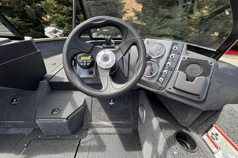 Slide: The Image of 2027 Tracker Pro Guide V-175 Combo boat dashboard with steering wheel and control panel. - 51