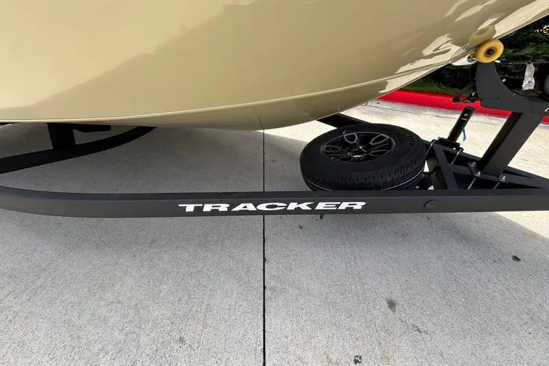 Slide: The Image of 2027 Tracker Pro Guide V-175 Combo boat trailer with spare tire on concrete surface. - 17