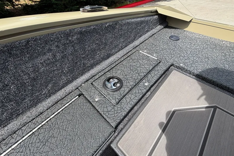 Slide: The Image of Interior view of 2027 Tracker Pro Guide V-175 Combo boat, featuring textured flooring and storage compartment. - 57