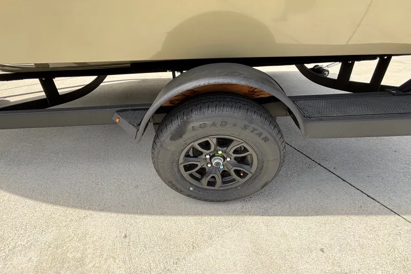 Slide: The Image of Trailer wheel of 2027 Tracker Pro Guide V-175 Combo on concrete surface. - 15