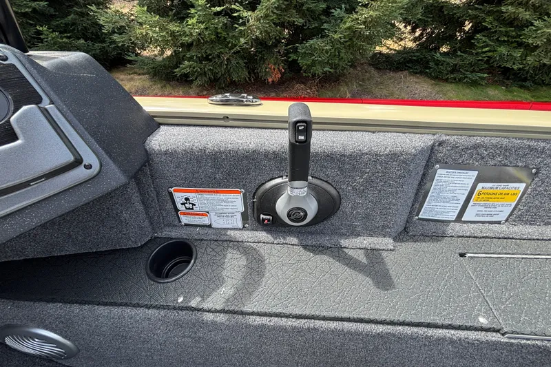 Slide: The Image of 2027 Tracker Pro Guide V-175 Combo boat control panel with throttle lever and safety warnings. - 52