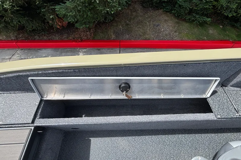 Slide: The Image of 2027 Tracker Pro Guide V-175 Combo boat interior with storage compartment and key. - 29