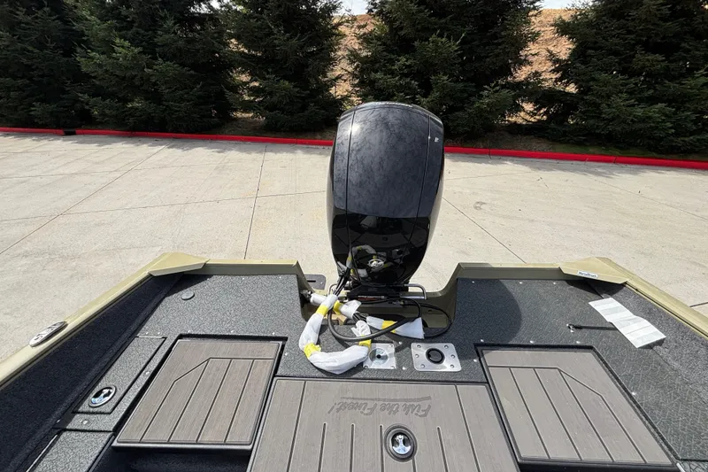 Slide: The Image of 2027 Tracker Pro Guide V-175 Combo boat with motor, parked on concrete near trees. - 23
